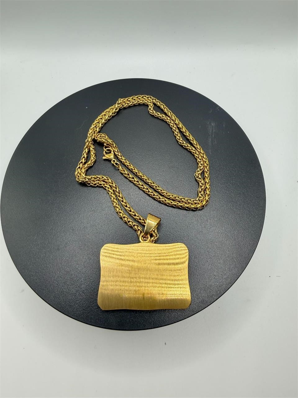 Gold Last Supper pendant with long chain jewelry by Republic Mercantile, featuring religious iconography and intricate design.