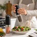 Azdele Gravity Electric Salt and Pepper Mill Set showing sleek black and silver grinders with clear spice chambers.