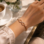 Rose gold Figure 8 fashion jewelry bracelet by Republic Mercantile featuring sleek, modern design with smooth curves and shiny finish.