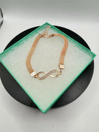 Rose gold figure 8 fashion jewelry bracelet with sleek design, featuring delicate links and a polished finish.