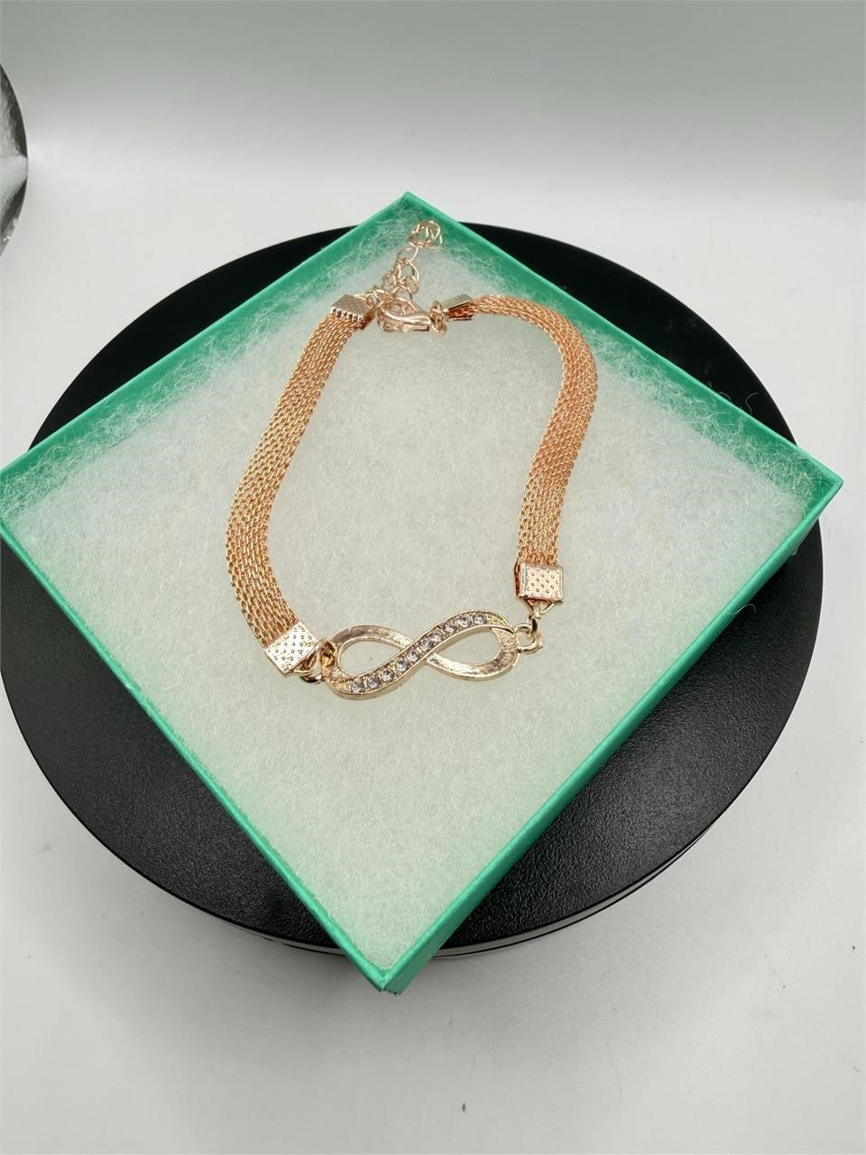 Rose gold figure 8 fashion jewelry bracelet with sleek design, featuring delicate links and a polished finish.