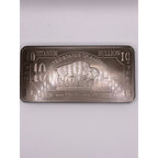 Ten Troy oz CMC Mint .999 fine titanium collectible bar with engraved details and serial number on a reflective surface.