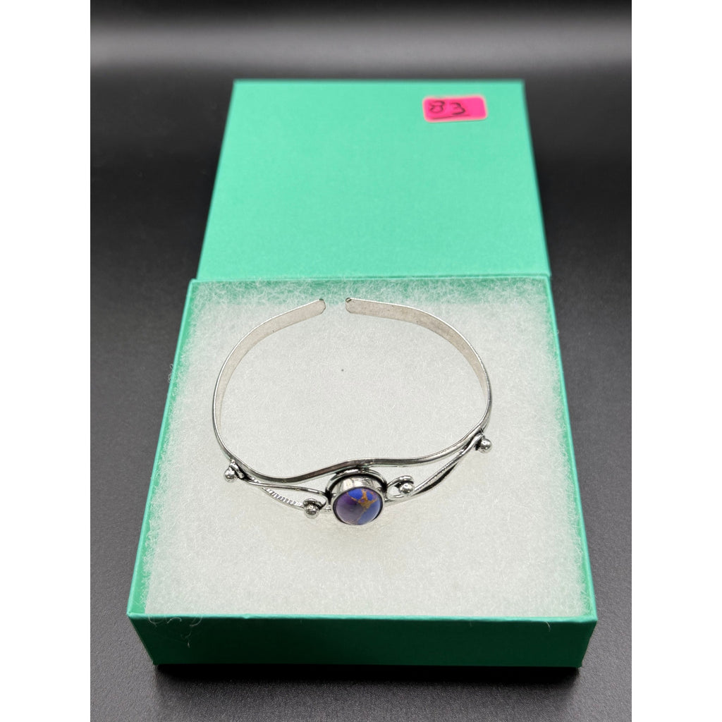 Silver plated bangle gemstone bracelet with handcrafted design from Republic Mercantile, featuring colorful gemstone accents.