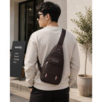 Jingpin daily single strap unisex crossbody backpack in coffee brown with adjustable strap and front pocket details.