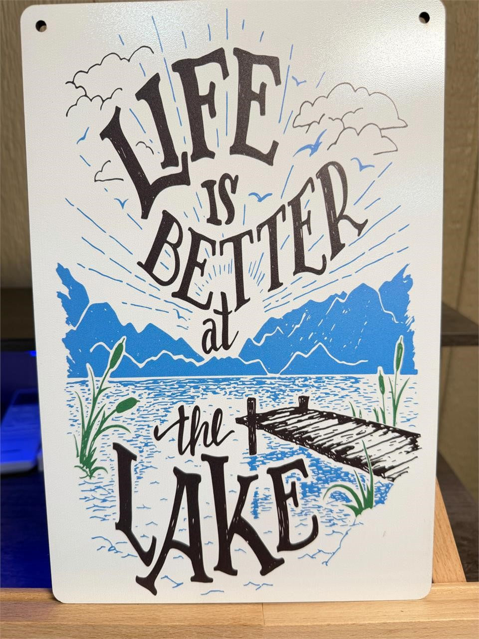 8x12 inch metal wall art by Republic Mercantile featuring a lake scene with "Life is Better At the Lake" rope design.