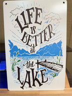 8x12 inch metal wall art by Republic Mercantile featuring a lake scene with "Life is Better At the Lake" rope design.