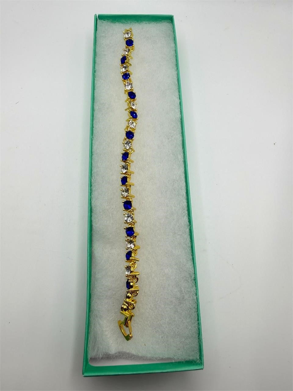 Blue and white gem bracelet set in gold tone with multiple bangles, stylish jewelry by Republic Mercantile.