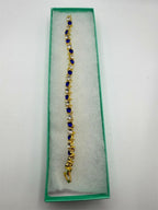 Blue and white gem bracelet set in gold tone with multiple bangles, stylish jewelry by Republic Mercantile.