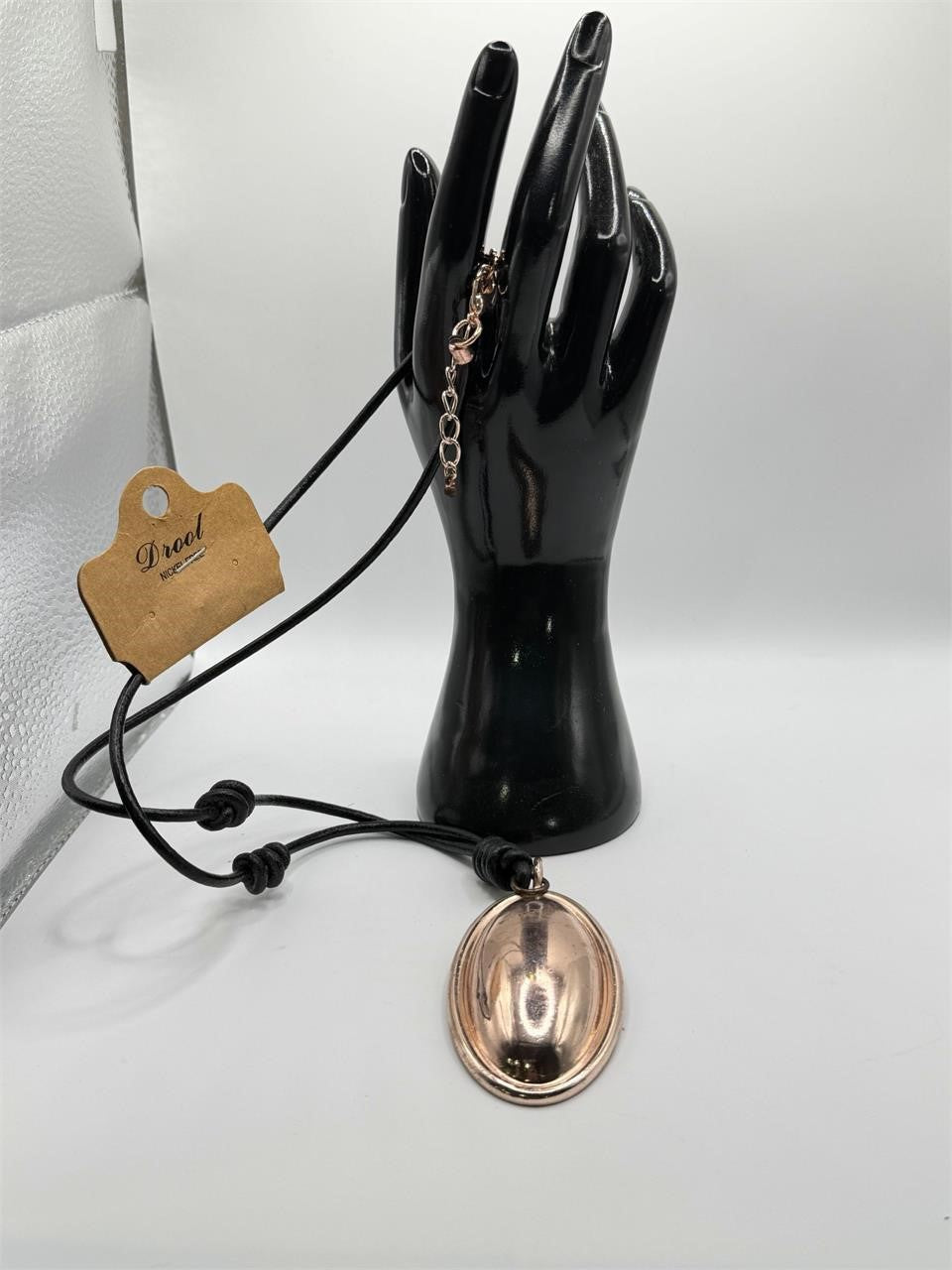 Drool rope necklace with copper pendant from Republic Mercantile, featuring a woven fabric cord and a round copper charm.