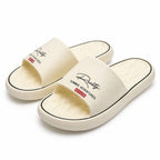 White BusyLion Comfort Slides in US size 6.5, showing the open-toe design and cushioned footbed.