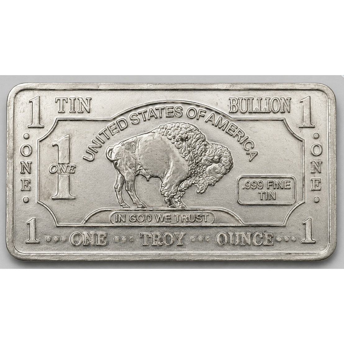 Close-up of a 1 Troy oz .999 Tin Collectible Bar from CMC Mint with detailed engravings and shiny metallic finish.