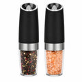 Azdele Gravity Electric Salt and Pepper Mill Set with sleek black and silver design, featuring clear spice chambers.