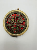 Large bejeweled pocket mirror with intricate gemstone detailing, branded by Republic Mercantile, resting on a neutral background.