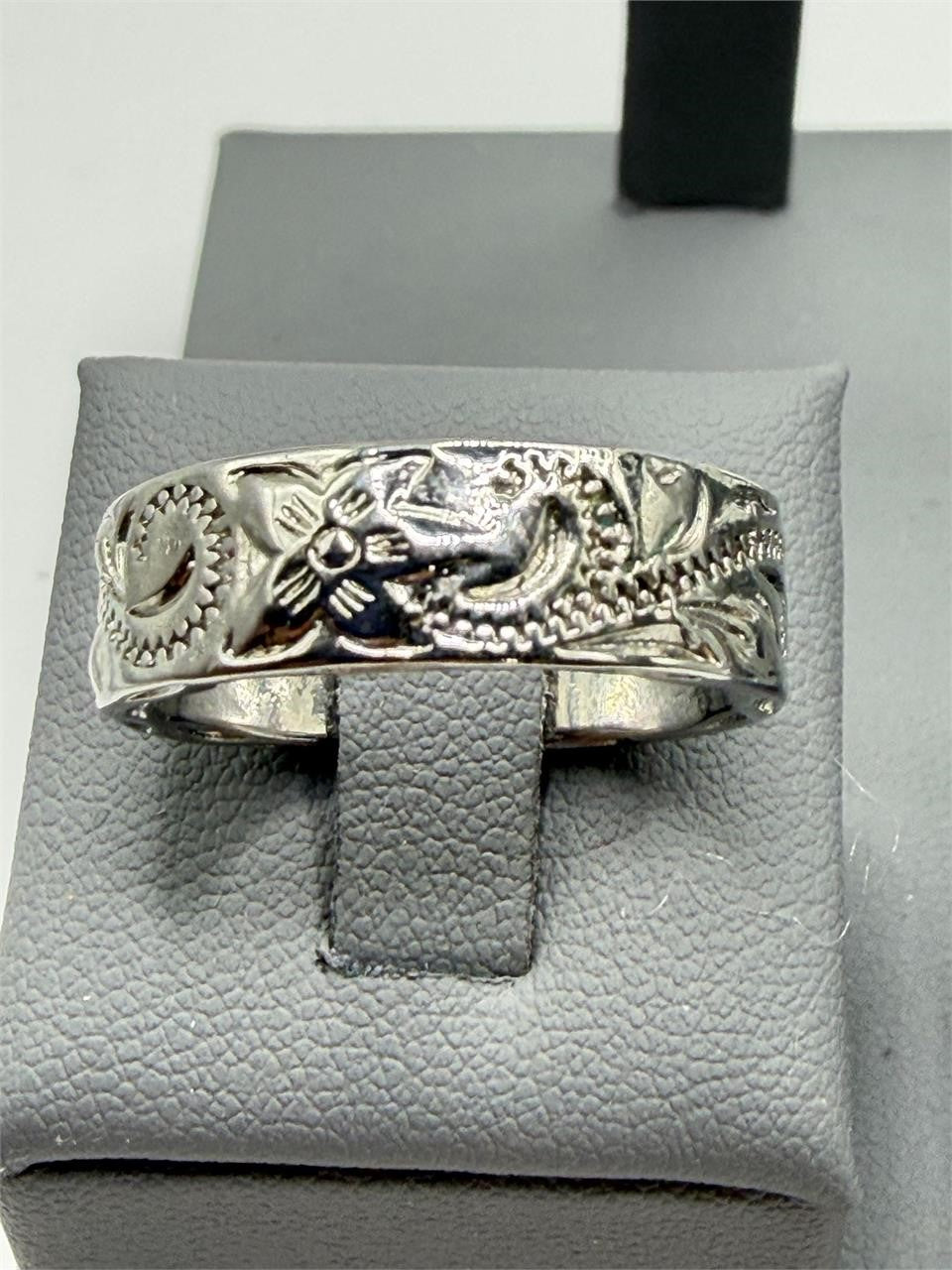 Carved silver men's ring in size 9 featuring intricate design, crafted by Republic Mercantile, displayed on a neutral background.