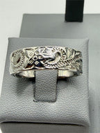 Carved silver men's ring in size 9 featuring intricate design, crafted by Republic Mercantile, displayed on a neutral background.