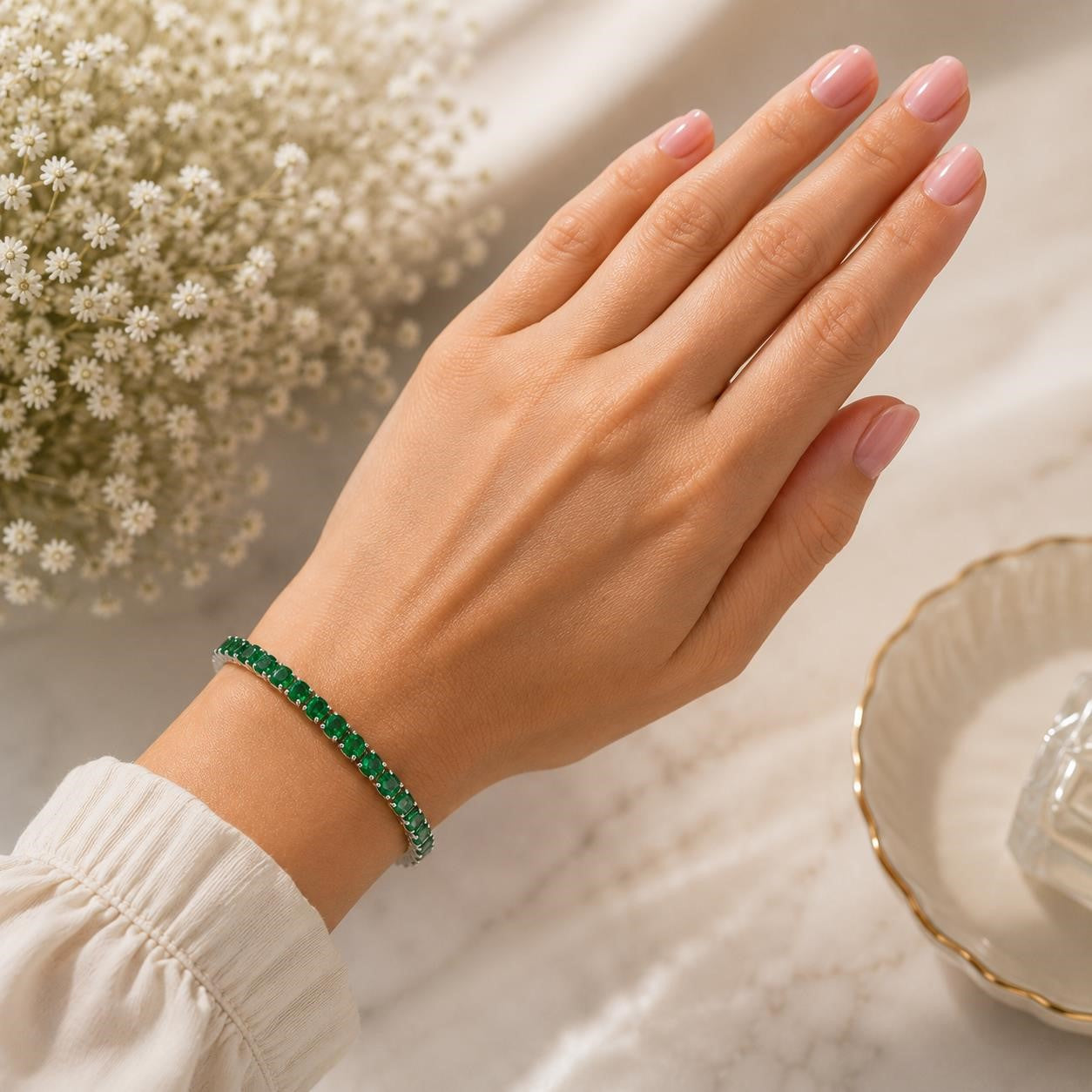 Silver tone women's bracelet featuring green gemstone accents, styled with a delicate design and elegant silver links.
