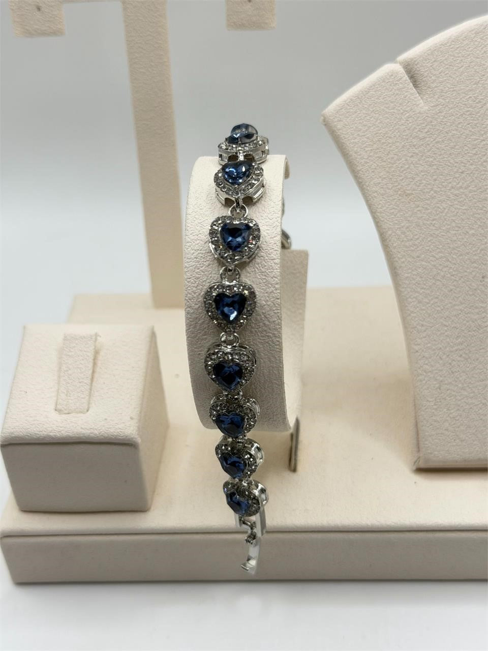 Beautiful blue tanzanite gemstone women's bracelet with silver setting, featuring sparkling oval stones and intricate design.