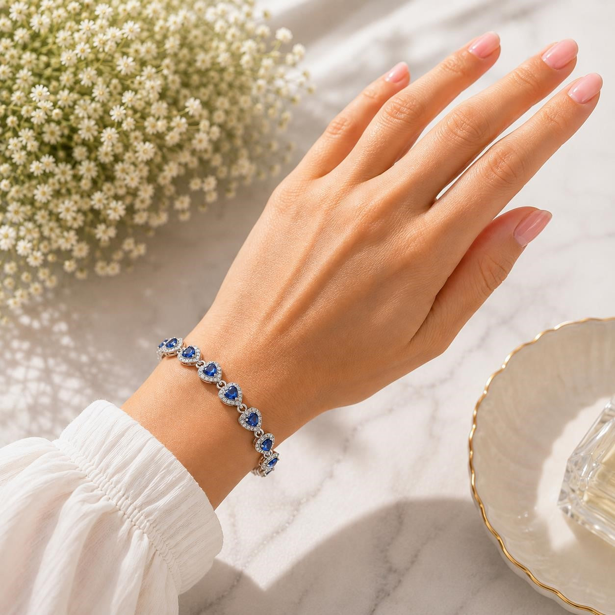 Gorgeous blue tanzanite gemstone women's bracelet with silver links, featuring vibrant, sparkling blue stones on a delicate chain.
