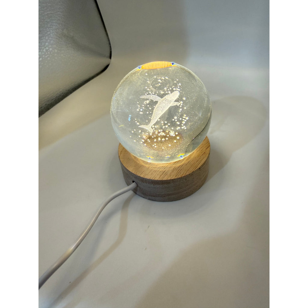 Blue whale laser etched crystal ball on LED stand, showcasing detailed marine design from Republic Mercantile.