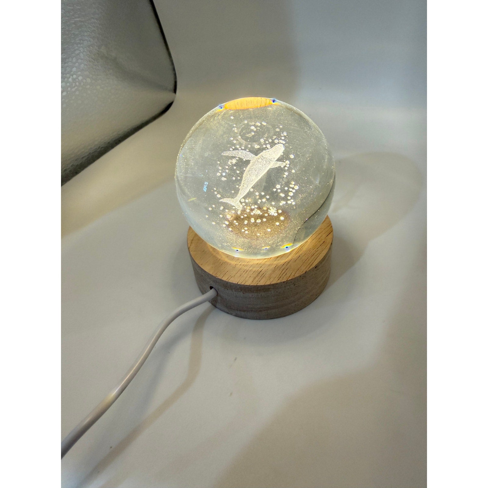 Blue whale laser etched crystal ball on LED stand, showcasing detailed marine design from Republic Mercantile.
