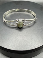Silver-plated bangle gemstone bracelet by Republic Mercantile with handcrafted design and decorative stones on a white background.