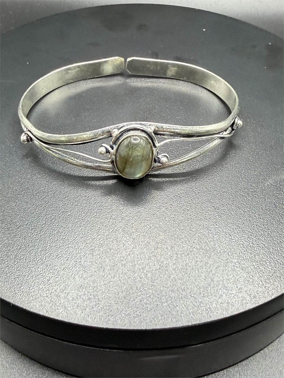 Silver-plated bangle gemstone bracelet by Republic Mercantile with handcrafted design and decorative stones on a white background.