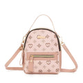 Pink Aohao heart shape crossbody backpack made of faux leather with zipper closure, stylish and compact for everyday use.