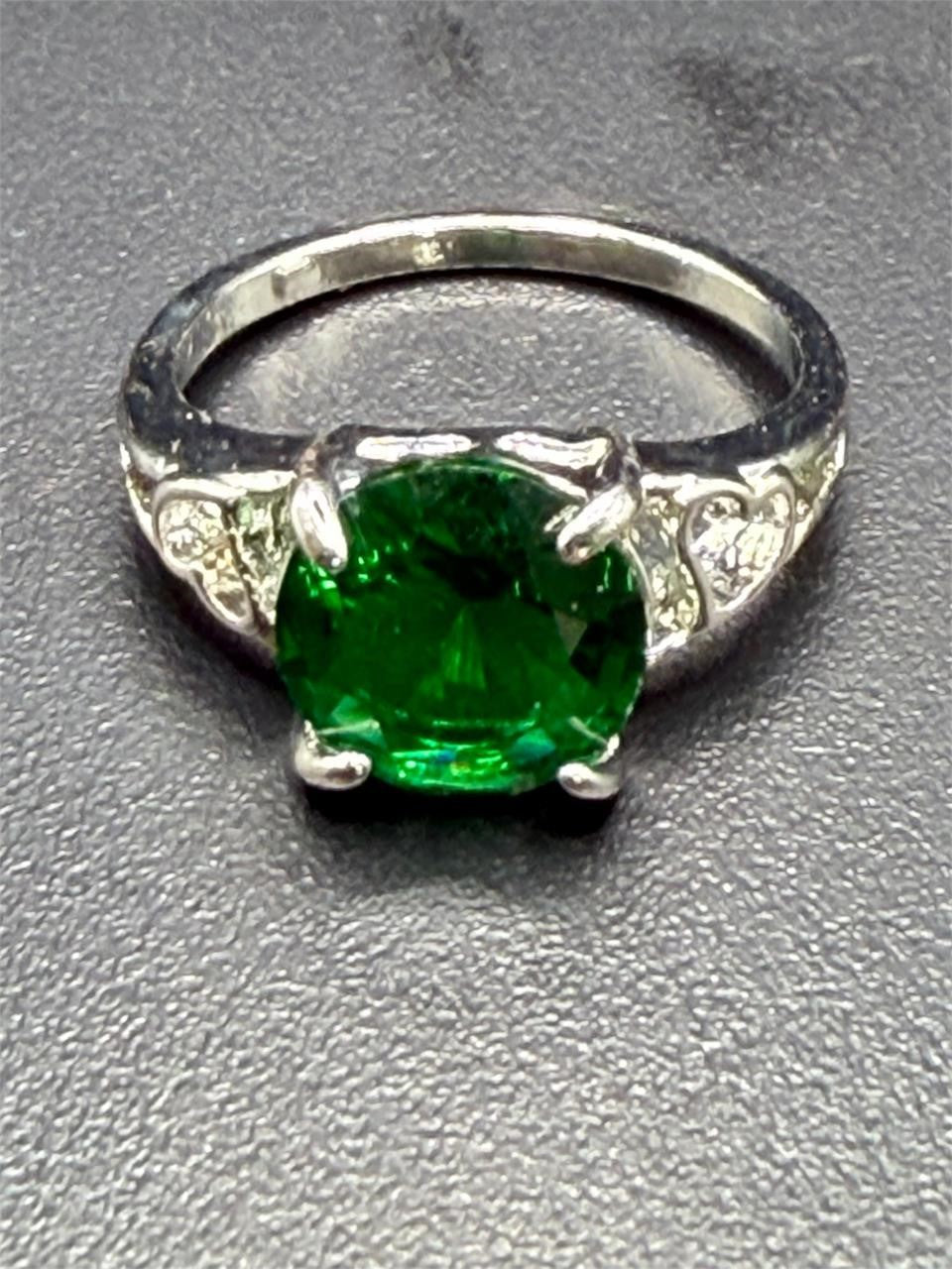 Sterling silver oval cut Helenite gemstone solitaire ring in size 8, featuring a polished band and a vibrant greenish gemstone.