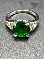 Sterling silver oval cut Helenite gemstone solitaire ring in size 8, featuring a polished band and a vibrant greenish gemstone.