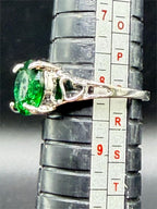 Sterling silver oval cut Helenite solitaire gemstone ring size 8, featuring a polished silver band and a vibrant green gemstone centerpiece.