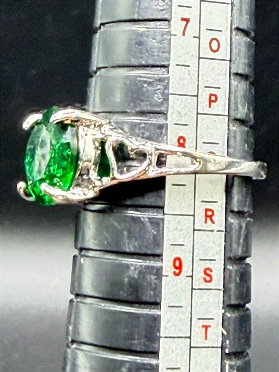 Sterling silver oval cut Helenite solitaire gemstone ring size 8, featuring a polished silver band and a vibrant green gemstone centerpiece.