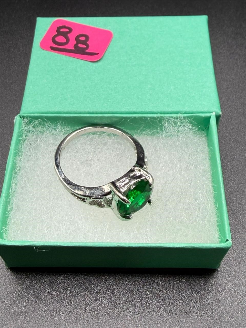Sterling silver oval cut Helenite solitaire gemstone ring in size 8, featuring a polished band and vibrant green center stone.