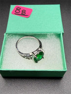 Sterling silver oval cut Helenite solitaire gemstone ring in size 8, featuring a polished band and vibrant green center stone.