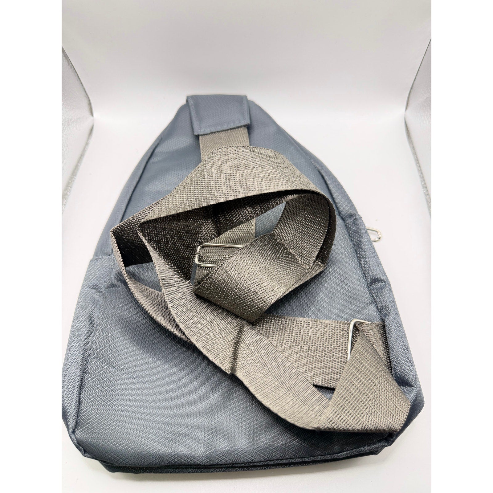 Gray Jingpin Daily single strap crossbody backpack with unisex design, featuring a compact, stylish look and adjustable strap.