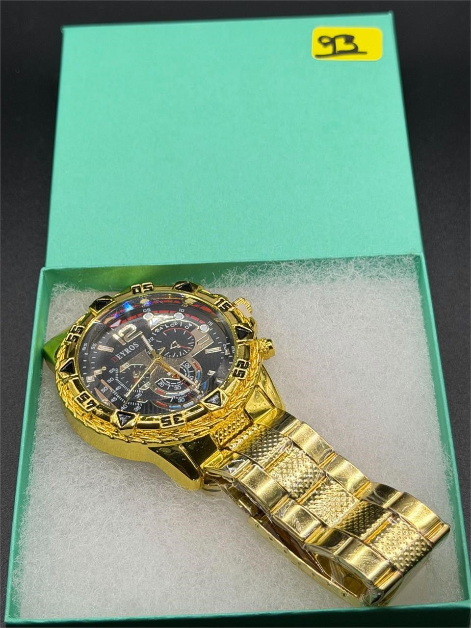Men's Deyros gold watch with matching band by Republic Mercantile, featuring a round dial and sleek gold finish.