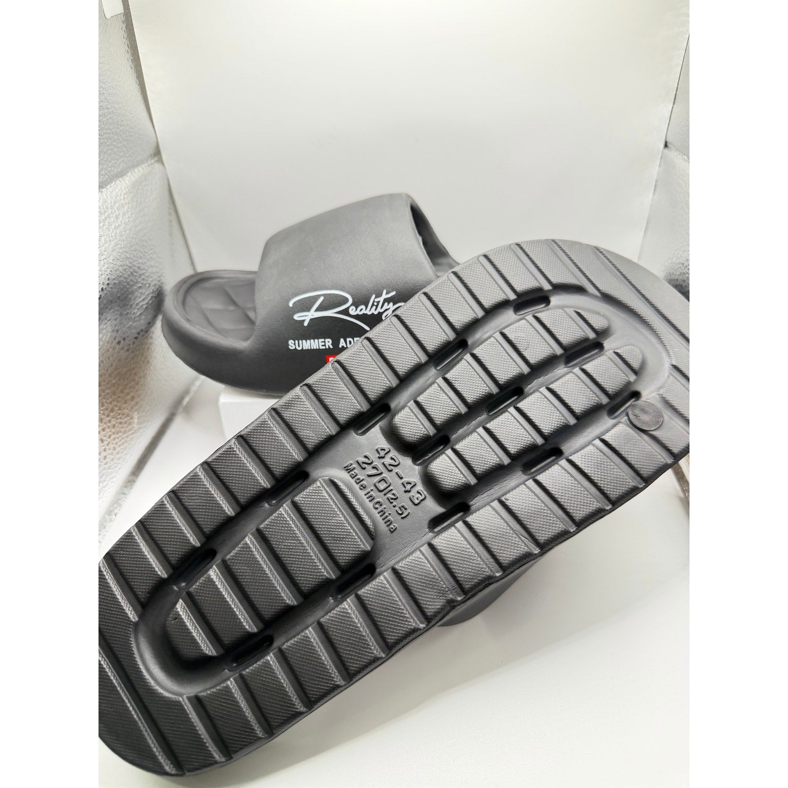 Black Busy Lion Reality Summer Adventures slides in size 9.5-10, featuring a playful lion design and comfortable slip-on style.