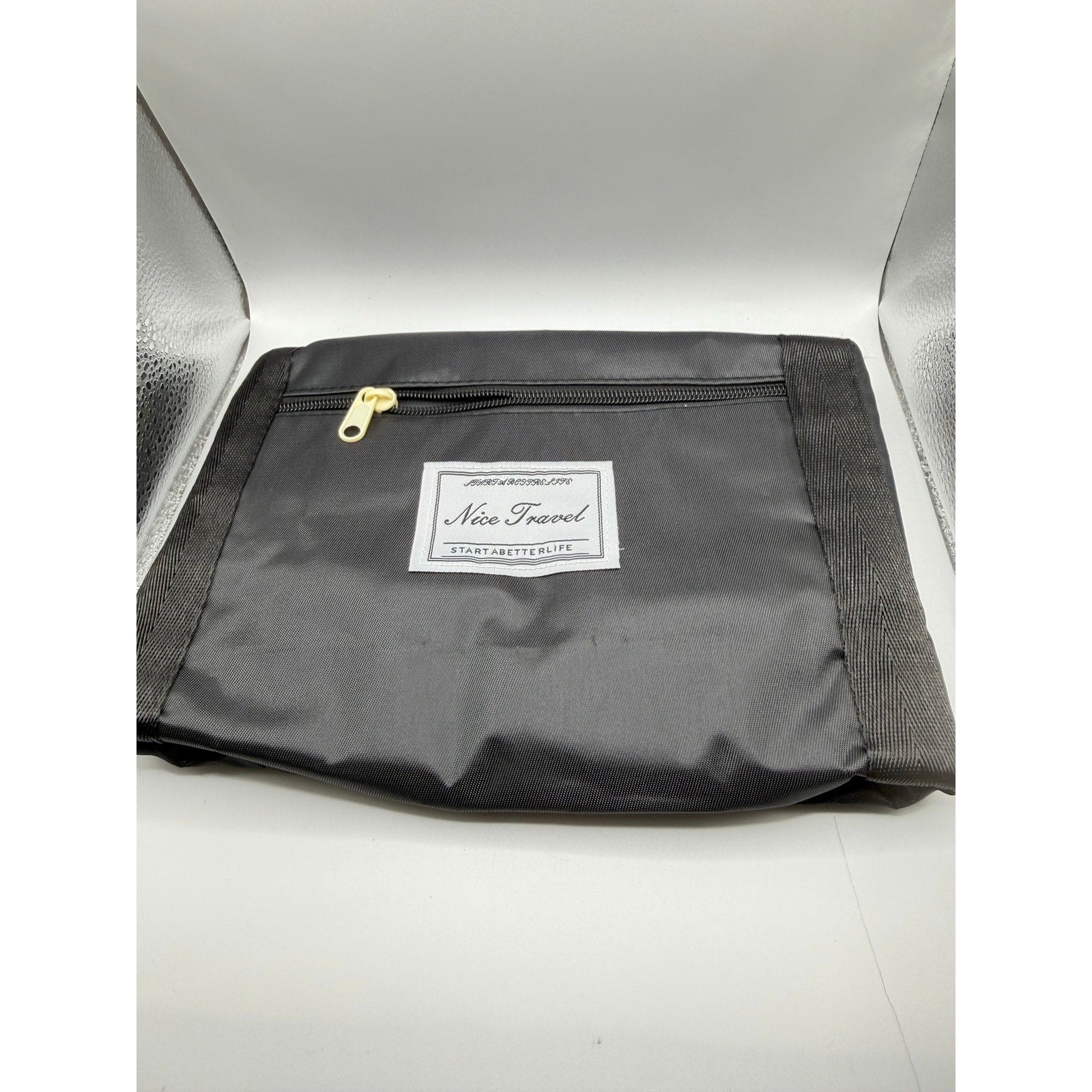 Black travel foldable tote bag measuring 13x16x4.5 inches by Nice Travel, shown folded and expanded for versatile carrying.