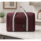 Nice Travel 11x16.5-inch Burgundy travel tote bag with sturdy handles and spacious interior for travel essentials.