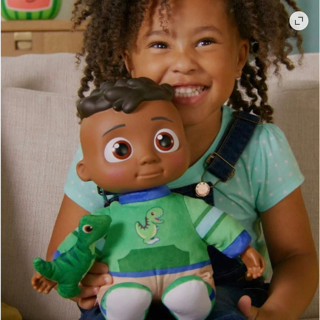 Cocomelon My Friend Cody plush toy with dinosaur, featuring a pressable tummy that plays music, soft fabric and detailed design.