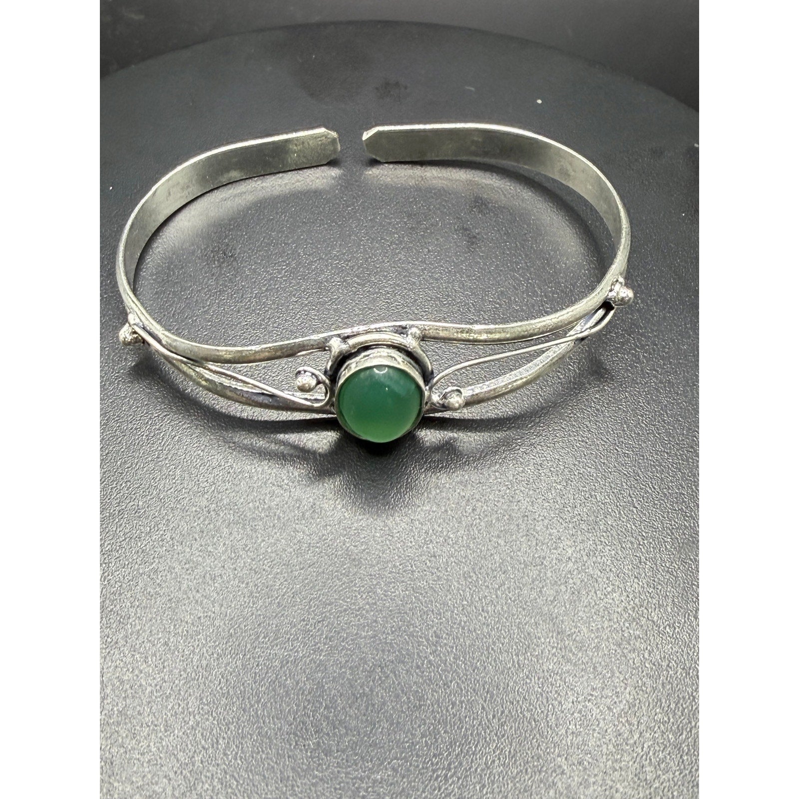 Silver plated bangle gem bracelet with handcrafted design, featuring sparkling gemstones and intricate silver detailing.