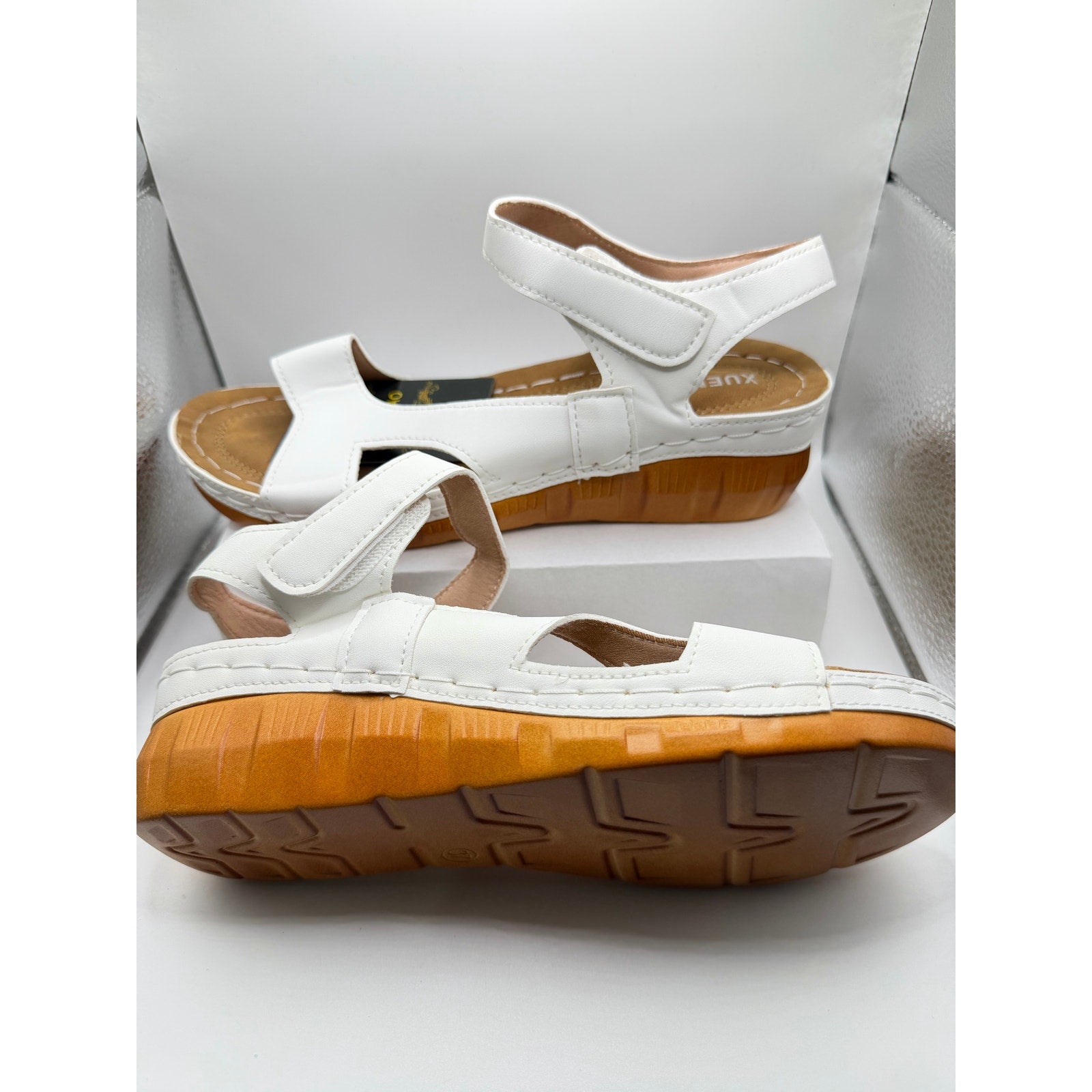 White women's cushioned strap sandals by Xuemjiao, size 6.5 (Euro 37), featuring comfortable padded straps and open toe design.
